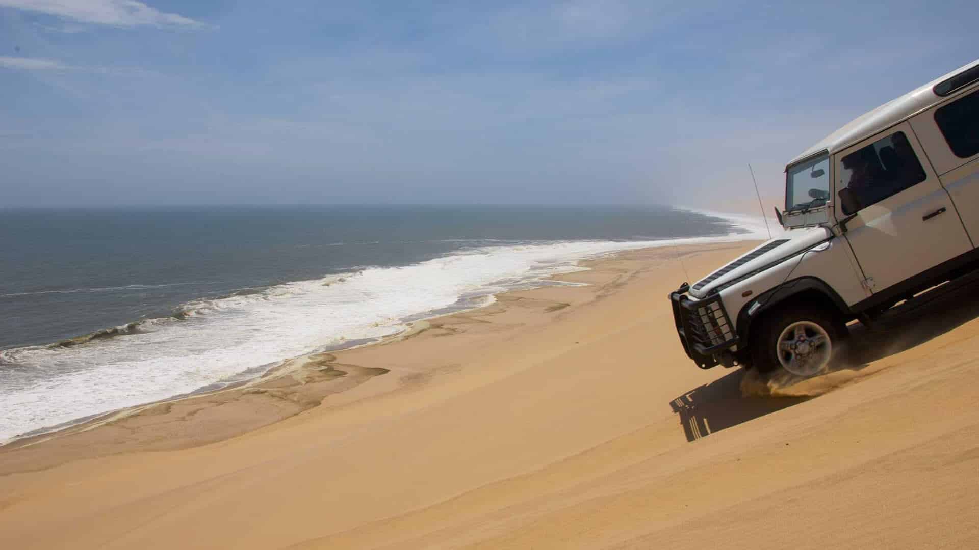 sandwich-harbour-namibia jeep giù dalla duna verso il mare a sandwich harbour